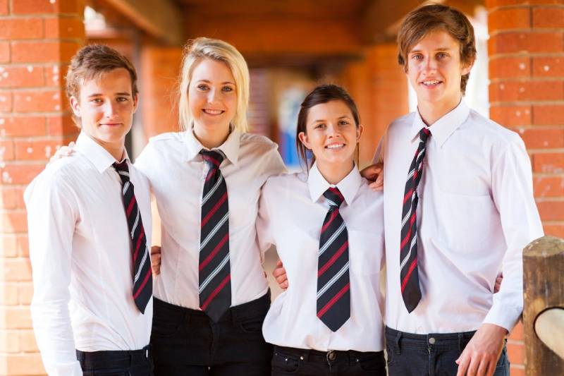 A group of people wearing ties and standing together.