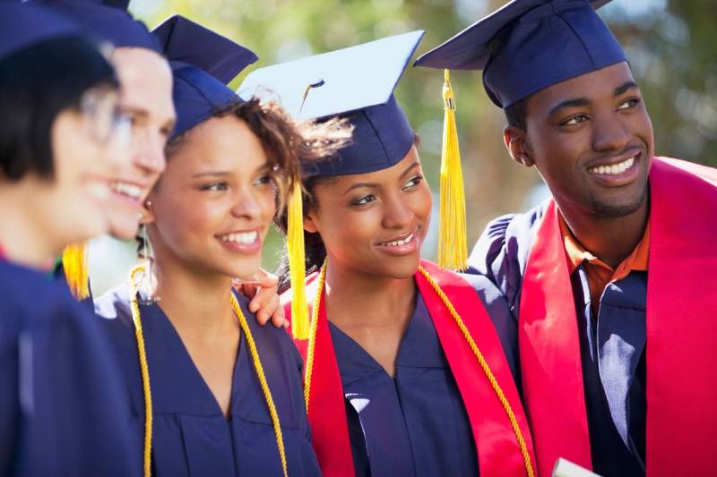 A group of graduates standing next to each other.