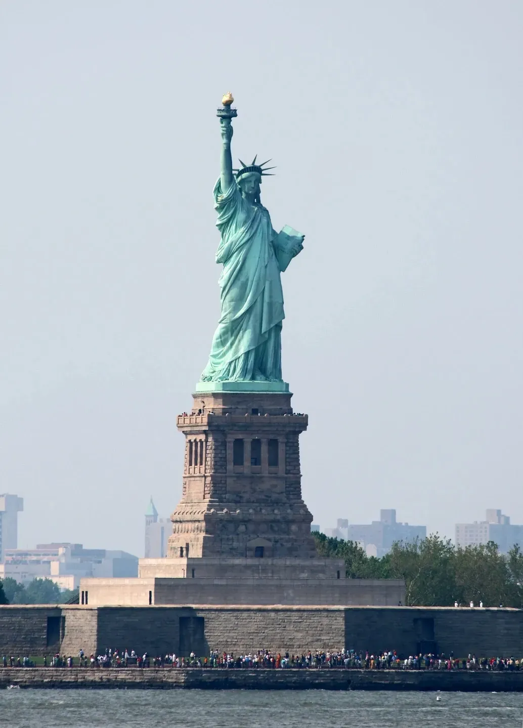 A statue of liberty on top of the island.